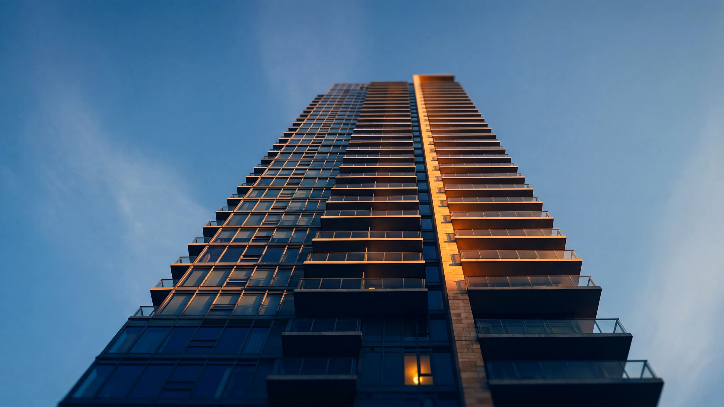 Brand imagery — the finished facade of a residential tower, ready to change hands.