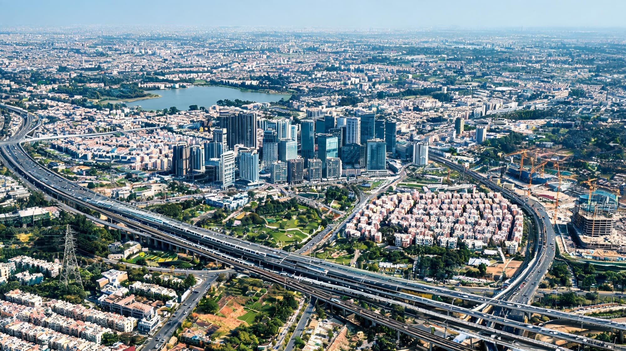 Brand imagery — a city corridor from above: highways, towers and homes, not a Catch9 project