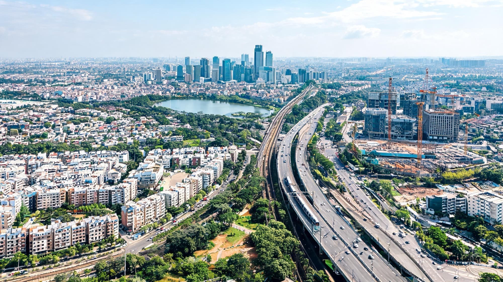 Brand imagery — an aerial view of a city corridor: a lake, highways and residential towers.