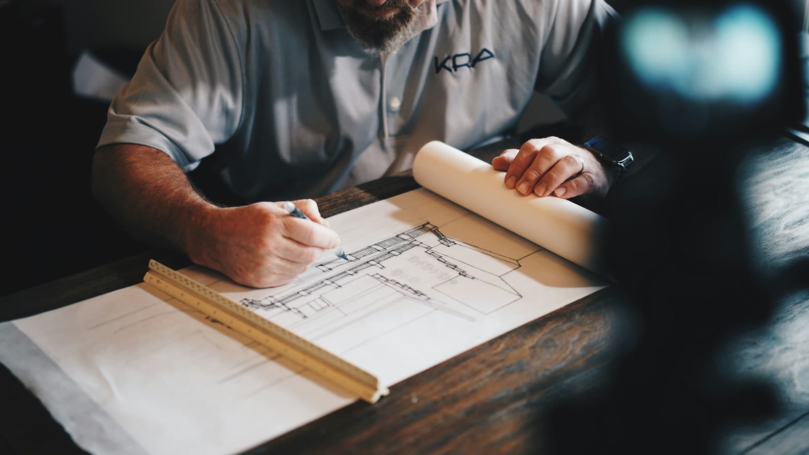 An architect drafting a plan by hand.